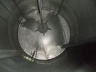 Used Saracco Tank & Mfg Approximately 5,200 Gallon Stainless Steel Storage Tank. Approximately 9' diameter x 11' straight side. Flat bottom and slight cone top. Various top openings including a 17
