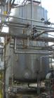 Used Walker Storage Tank, 16,000 Gallon, 316L stainless steel, vertical. Approximate 12' diameter x 18' straight side, dish top and bottom. Misc top and side flanged openings. Side openings include a...