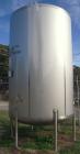 USED: Walker 5,000 gallon, type 304L stainless steel, storage tank. Vertical, dished heads. Approximate 8' diameter x 12' straight side. Misc top and side flanged openings. Bottom has a 2