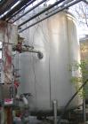 USED: Walker 10,000 gallon, type 304L stainless steel, storage tank. Vertical, dished heads. Approximate 11' diameter x 12' straight side. Misc top and side flanged openings. Side openings include an...