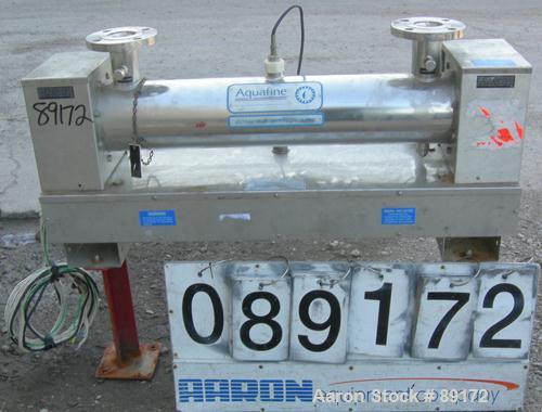 Used Aquafine Ultraviolet Disinfection Unit, 316 stainless steel. Approximate 4" diameter x 30" long tube. 2" inlet/outlet. Mounted on 2 carbon steel legs.